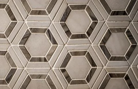 Vitrified tiles in a hexagonal geometrical pattern with grey and white textur Fotos de archivo