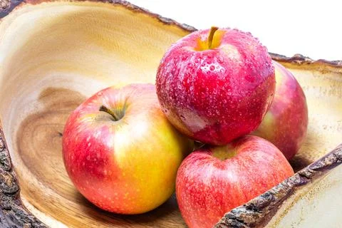 Vivid and fresh couple of red apples in wooden basket Stock Photos