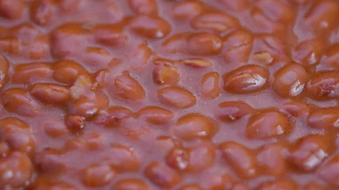Vivid bean closeup, Closeup of simmering red beans with rich textures and warmth Video stock 325655238