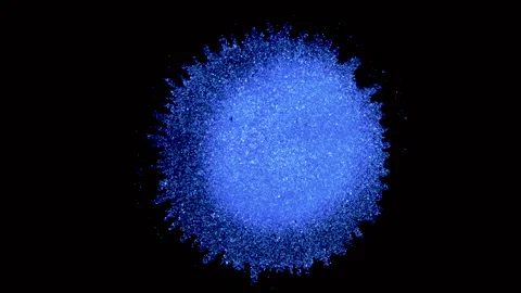 Vivid Blue dot expands out in river pattern on Black background.  Macro Abstract Video stock 135574577
