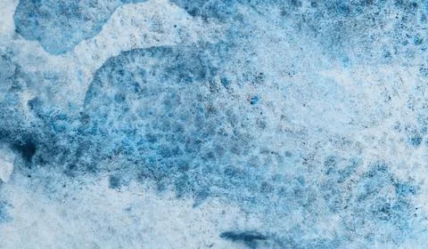Vivid blue ink patterns create art on textured paper surface Illustrazione stock