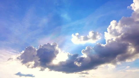 Vivid Blue Sky with Cumulus Clouds and Sun Rays Stock Footage 311587176