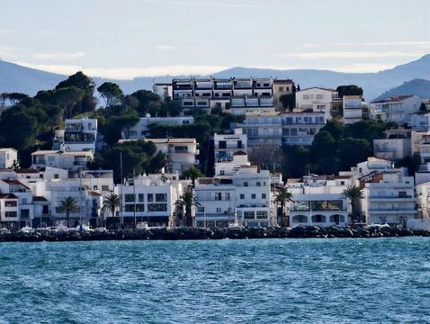 Vivid Coastal Harbor Structures, Vibrant Harborfront Buildings Facing Blue Sea Stock Photos