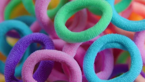 Vivid colors rotating close up textile rubber bands Stock Footage 301861976