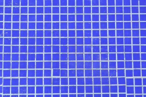 Vivid dark blue background texture of tile mosaic swimming pool floor without Stock Photos