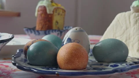 Vivid Easter eggs with bread. Festive setting featuring colorful eggs and Stock Footage 332735071