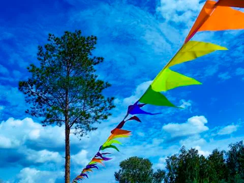 Vivid festive holiday triangular colored flags. Multicolor flag's festoon in  Stock Photos