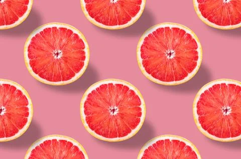 Vivid fruit pattern of fresh grapefruit on colourful background Stock Photos