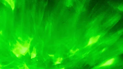 Vivid green liquid light ripple texture flowing across textured wall in luminous Stock Footage 332007241