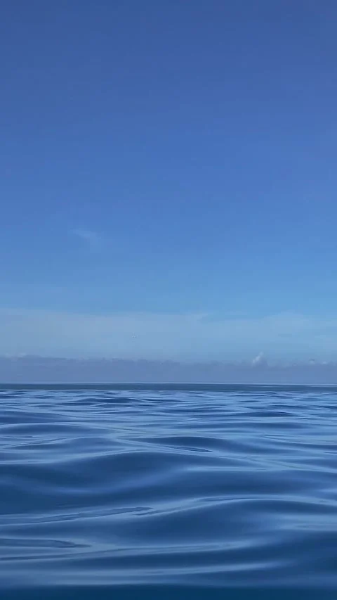 Vivid marine scene featuring sunlight and distant island outline Stock Footage 335591708