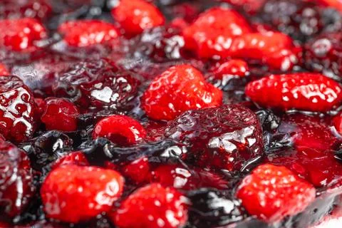 Vivid mixture of berries with glossy surface and shimmering syrup, Bright and co Foto stock