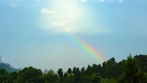Vivid Rainbow Arching Over Landscape After a Summer Thunderstorm Stock Footage 333043026
