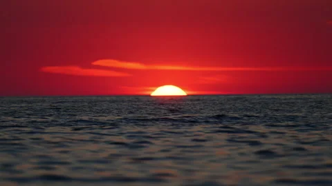 Vivid red sun touching ocean horizon, peaceful Italy sunset scene in 4K slow Stock Footage 334318096