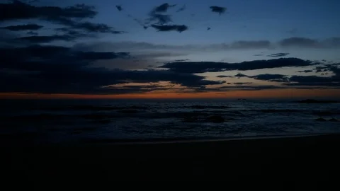Vivid sky and dark clouds over ocean at dusk just after sunset Stock Footage 106648267