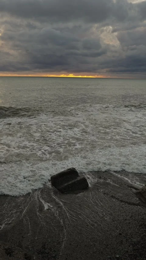 Vivid stormy horizon casting shadows over turbulent sea waves 動画素材 335950603