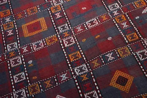 A vivid textile featuring a geometric grid of red and grey blocks Stock Photos