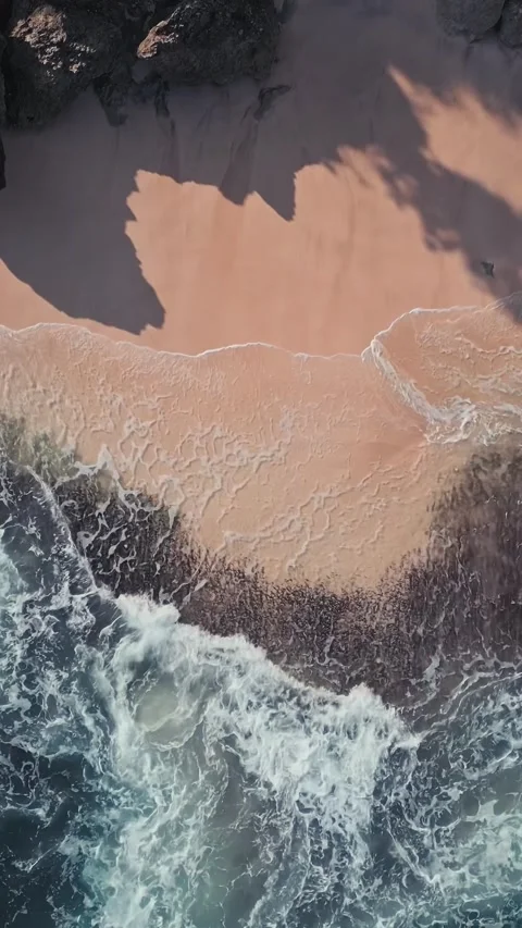Vivid waves energetically collide with colorful rocky sandy beach landscape Stock Footage 337135557