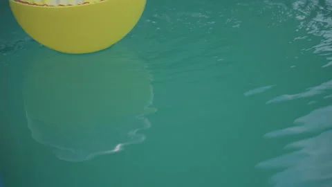Vivid Yellow Float Resting On Tranquil Teal Liquid With Ripples, Cheerful Summer 動画素材 327092231