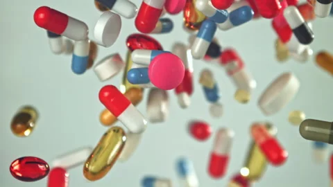Vividly colored tablets cascading rapidly past camera lens view Filmed on a high Stock Footage 335424164