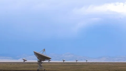 VLA, Very Large Array, of satellites with storm clouds Stock Footage 112952878
