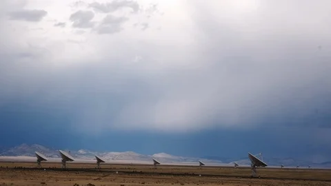 VLA, Very Large Array, of satellites with storm clouds Stock Footage 112953269