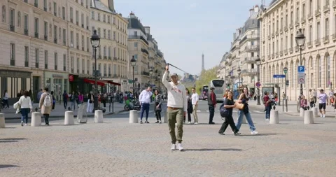Vlogger filming with 360 camera in street in Paris, France Stock Footage 334371330