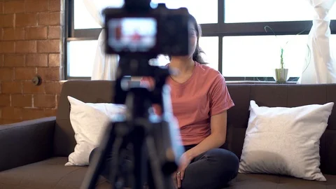 Vlogger girl streaming to social networks with a camera, behind scene Stock Footage