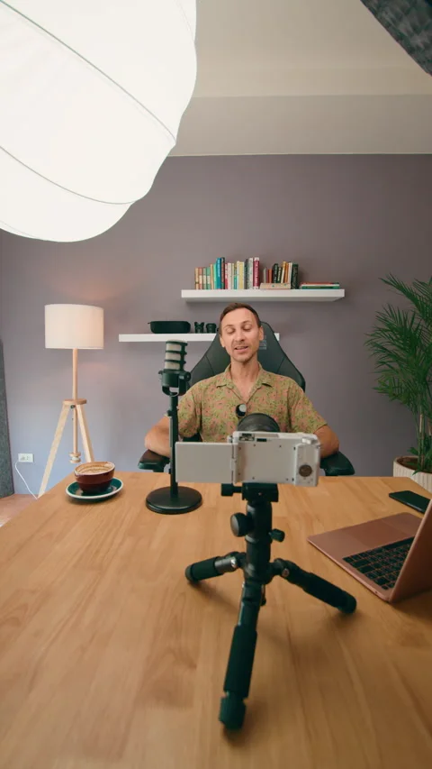 A Vlogger in a Home Studio with Microphone and Camera focuses on producing 動画素材 276341413