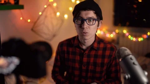 Vlogger influencer creating explainer video. Young blogger hipster in black hat Stock Footage 120775511