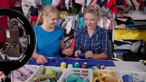 The vloggers chose the right color of thread for the fabric from which the Video stock 244767806