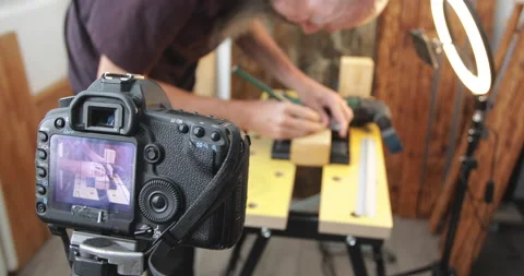 Vlogging, woodworking, drawing cutting lines on wood block, filming Stock Footage 154796548