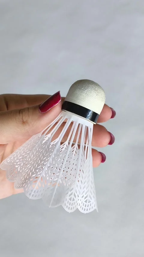 Vlonaczyk in a womans hand on a white background close-up. Badminton Stock Footage 318133327