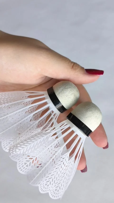 Vlonaczyk in a womans hand on a white background close-up. Badminton Stock Footage 318133350