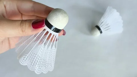 Vlonaczyk in a womans hand on a white background close-up. Badminton Stock Footage 318133435