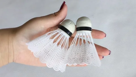 Vlonaczyk in a womans hand on a white background close-up. Badminton Stock Footage 318133500