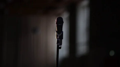 Vocal stage microphone holding on microphone stand on the stage dark background. Stock Footage 88025236