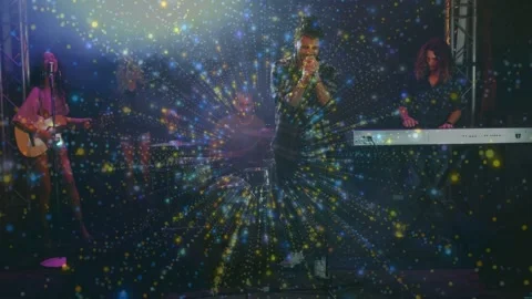 Vocalist holding mic and singing on stage, burst overlay rising from center and Stock Footage 333911399
