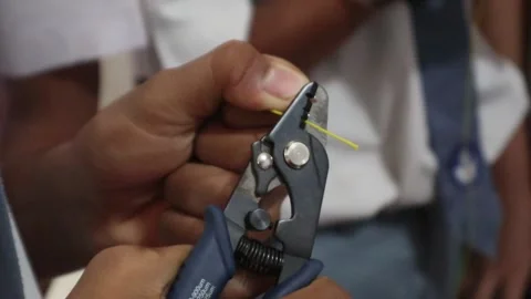 Vocational high school students practicing cutting fiber optic cables Stock Footage 307371166