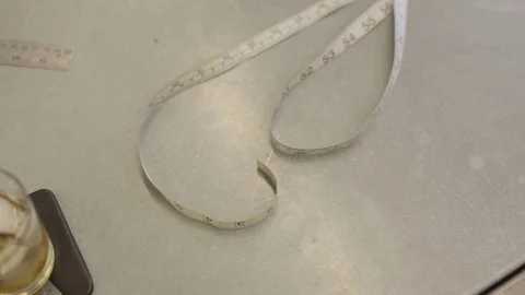 Vodka and Measuring Tape in Tailor Shop Stock Footage 76356443