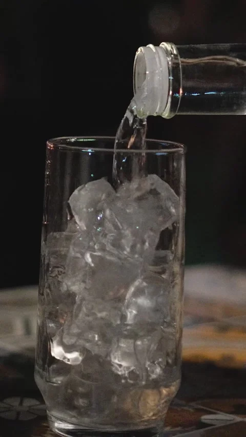 Vodka Being Poured into Ice-Filled Glass for Wedding Reception Cocktail and 動画素材 345111234
