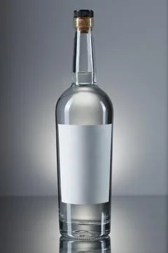 Vodka bottle on a grey gradient background. side view. Stock Photos