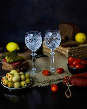 Vodka with garnish lemon,olives,bread Stock Photos
