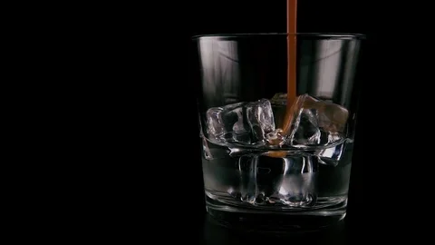 Vodka with ice in a glass on a table. Slow mo Stock Footage 76434341