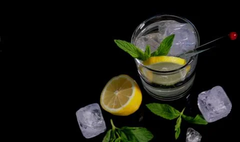 Vodka lemon with lemon slice in  black background. Stock Photos