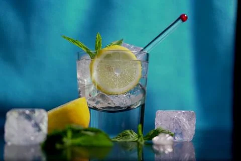 Vodka lemon with lemon slice in  blue background. Stock Photos