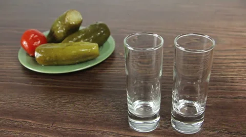Vodka poured into two glasses Video stock 61435712