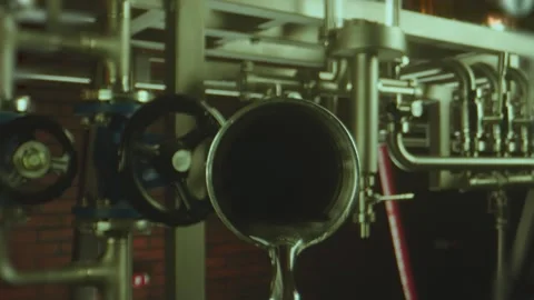 Vodka pouring from tube inside professional alcohol production factory . 動画素材 197522656