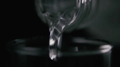 Vodka pours from a bottle close-up. Slow motion Video stock 74620246