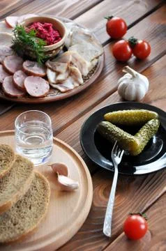 Vodka with salted cucumbers, rye bread and lard Stock Photos