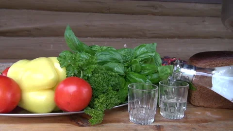 Vodka served with tomatoes, lettuce and some peppers Stock Footage 239567465